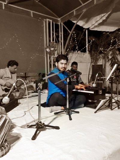 Sunil and musicians performing together on stage